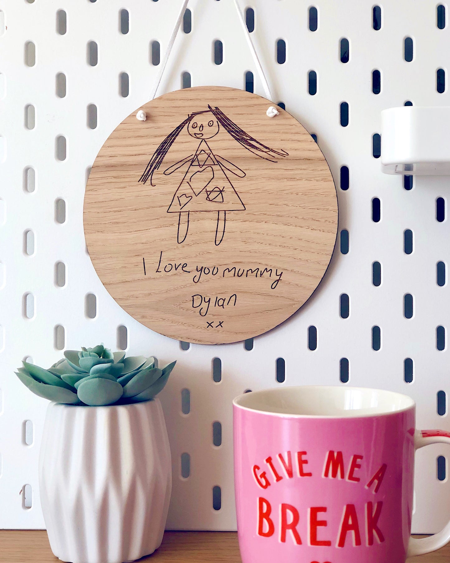children's drawing engraved into a circular wooden plaque