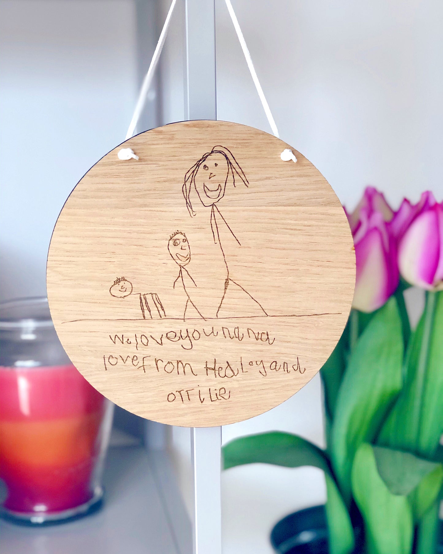 children's drawing engraved into a circular wooden plaque