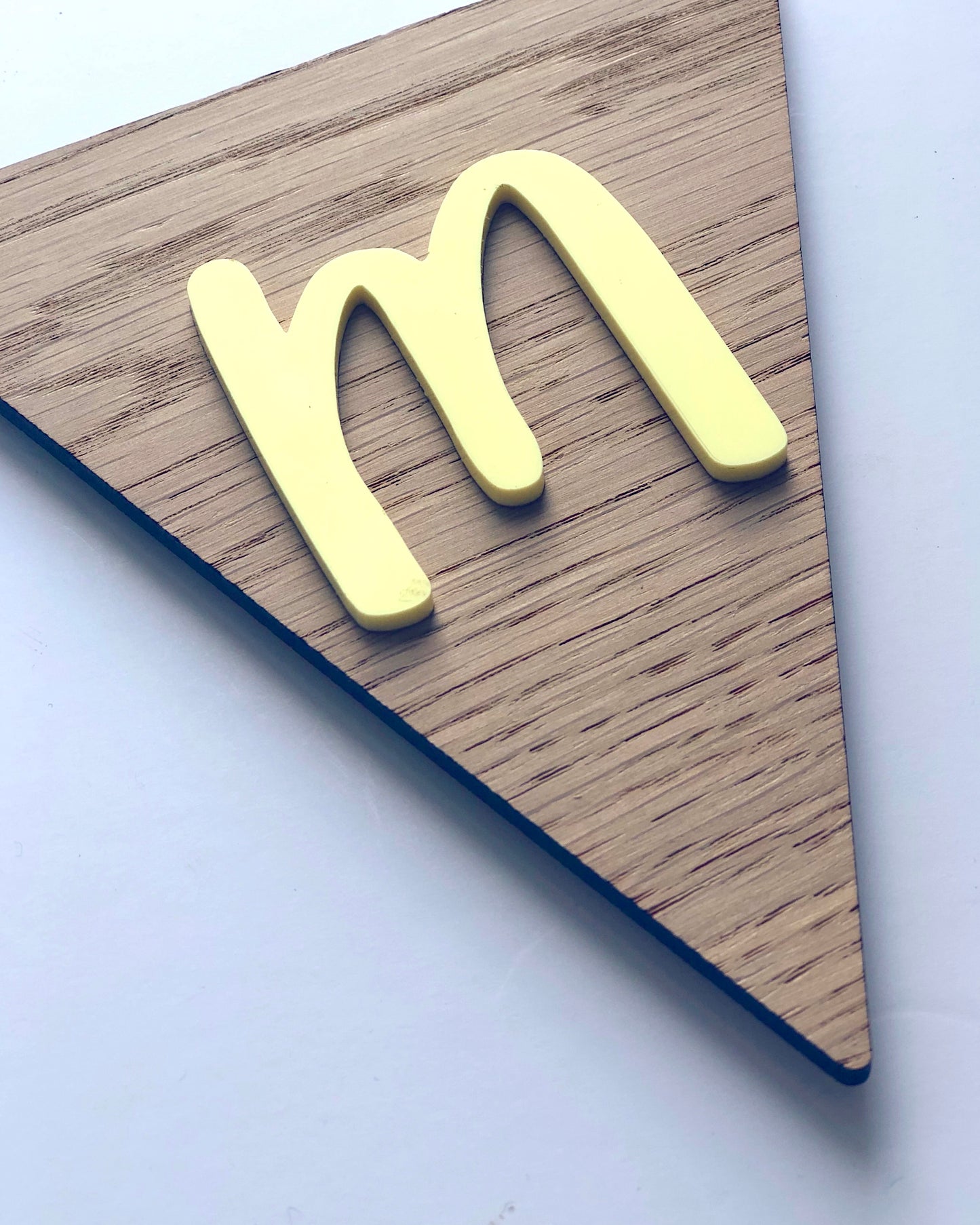 wooden bunting flag with the letter m in pastel yellow acrylic