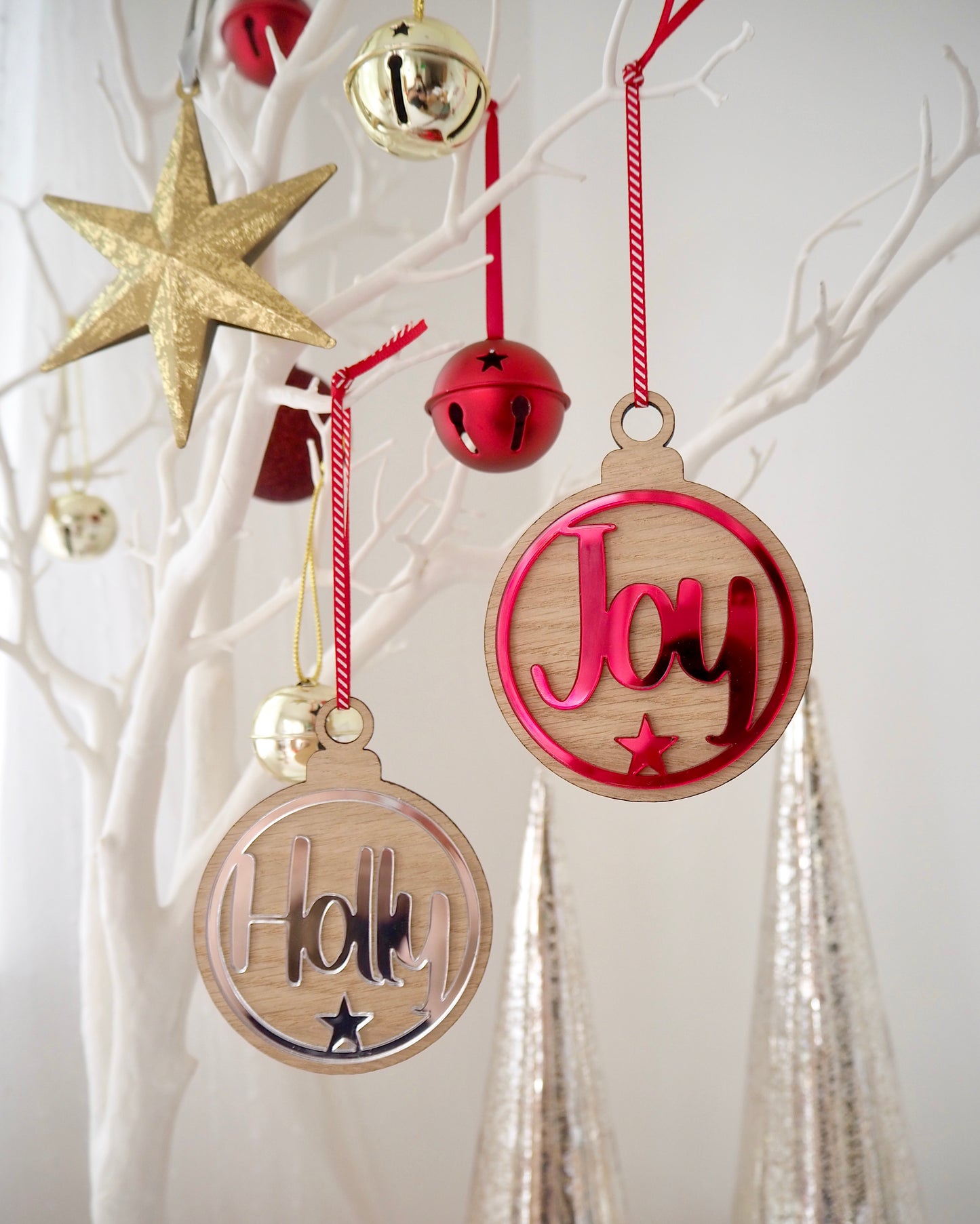 Wooden Christmas baubles with metallic acrylic in red or silver. Personalised with a name