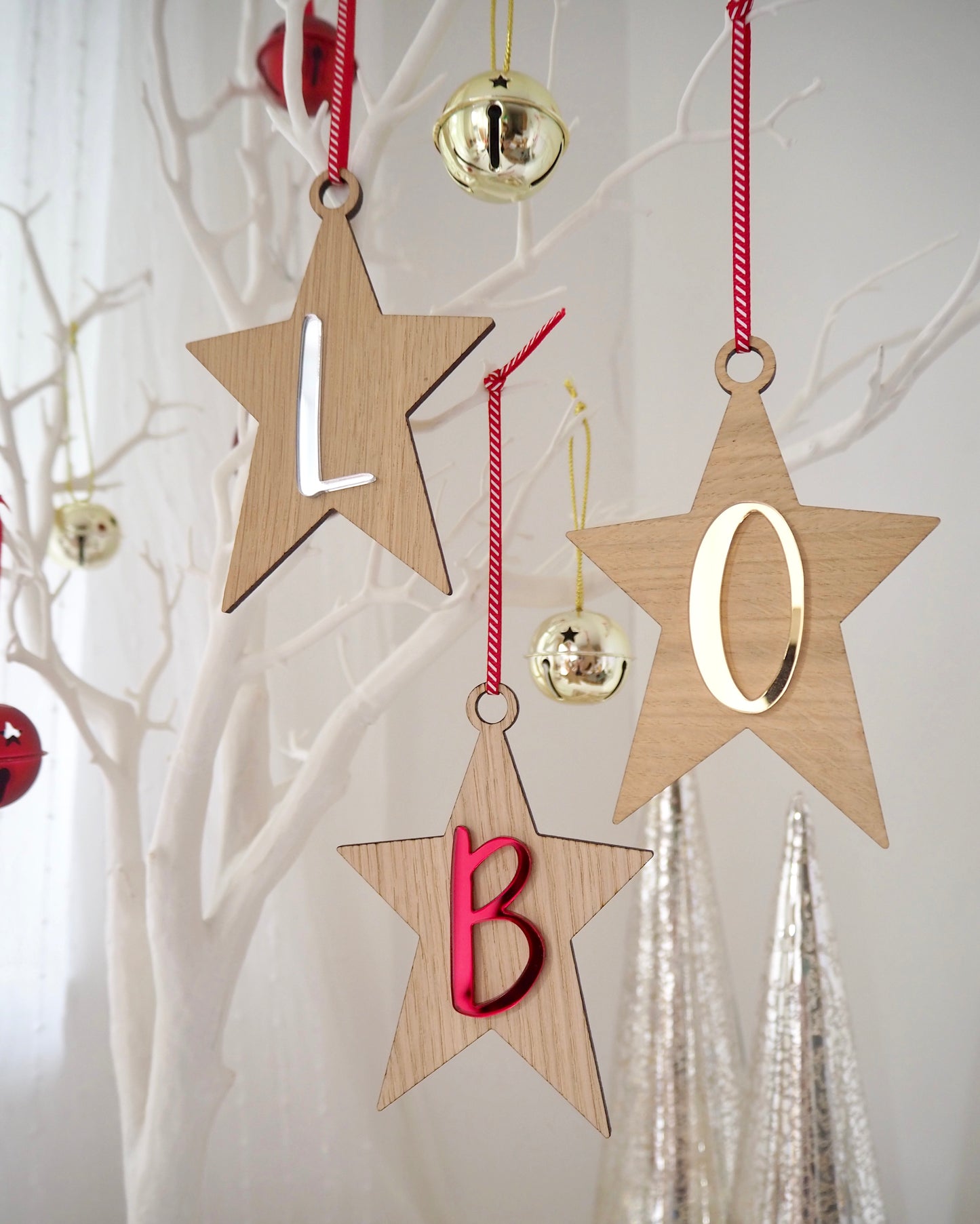 Wooden star decorations with red, gold and silver letters on