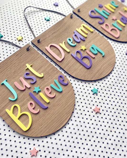3 positive wooden wall hangings with colourful pastel lettering
