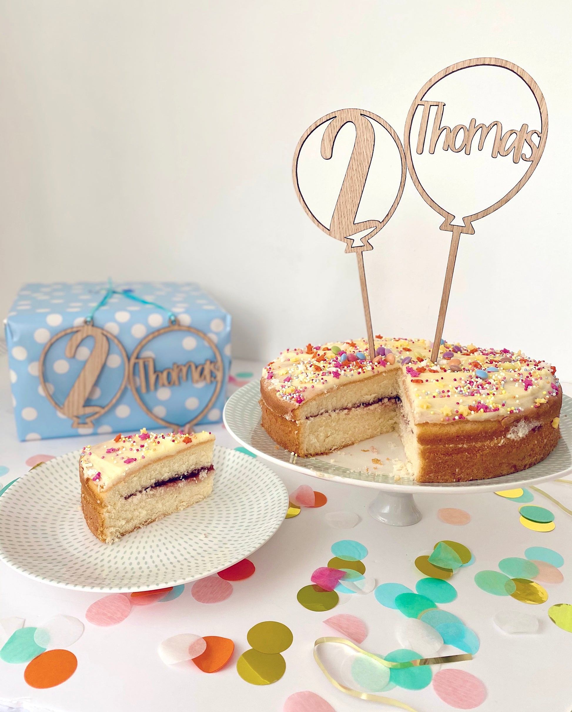 Birthday cake and present with personalised balloon shaped cake toppers and gift tags made from wood