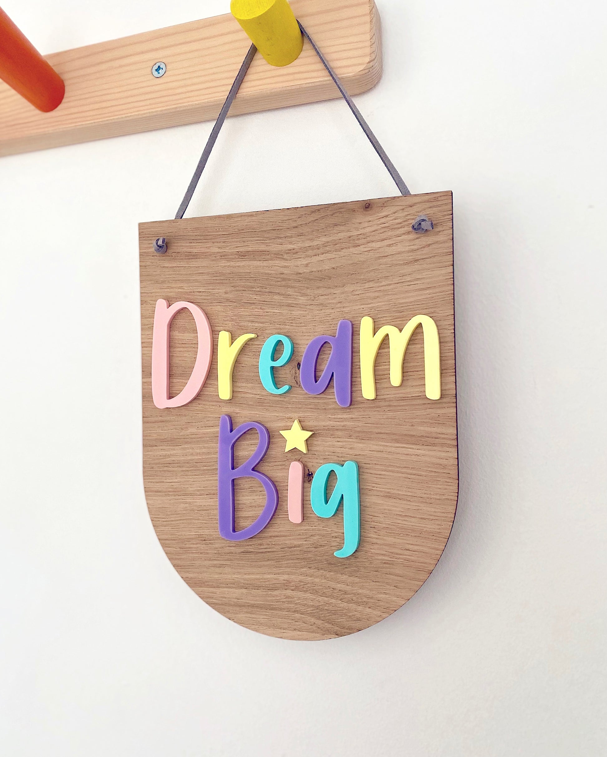Dream Big wooden wall hanging with pastel multicoloured lettering