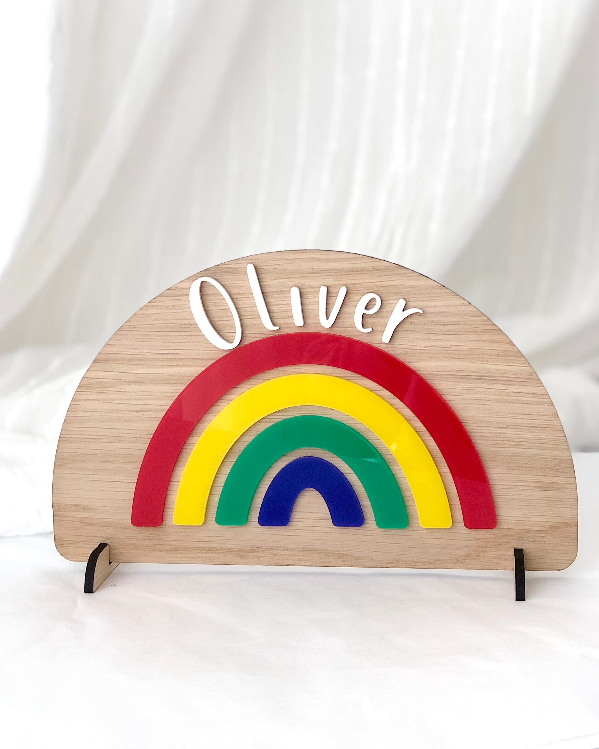 personalised wooden and acrylic colourful rainbow. Freestanding with child's name
