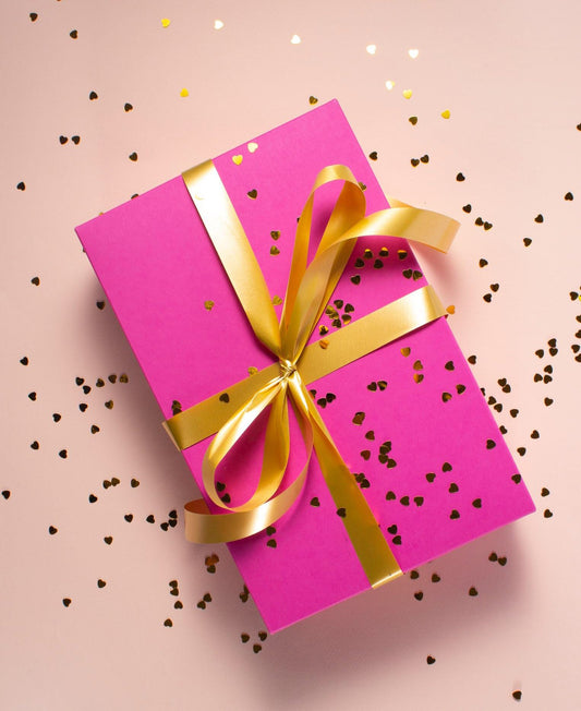 Pink present with gold ribbon and sprinkles - gift card image