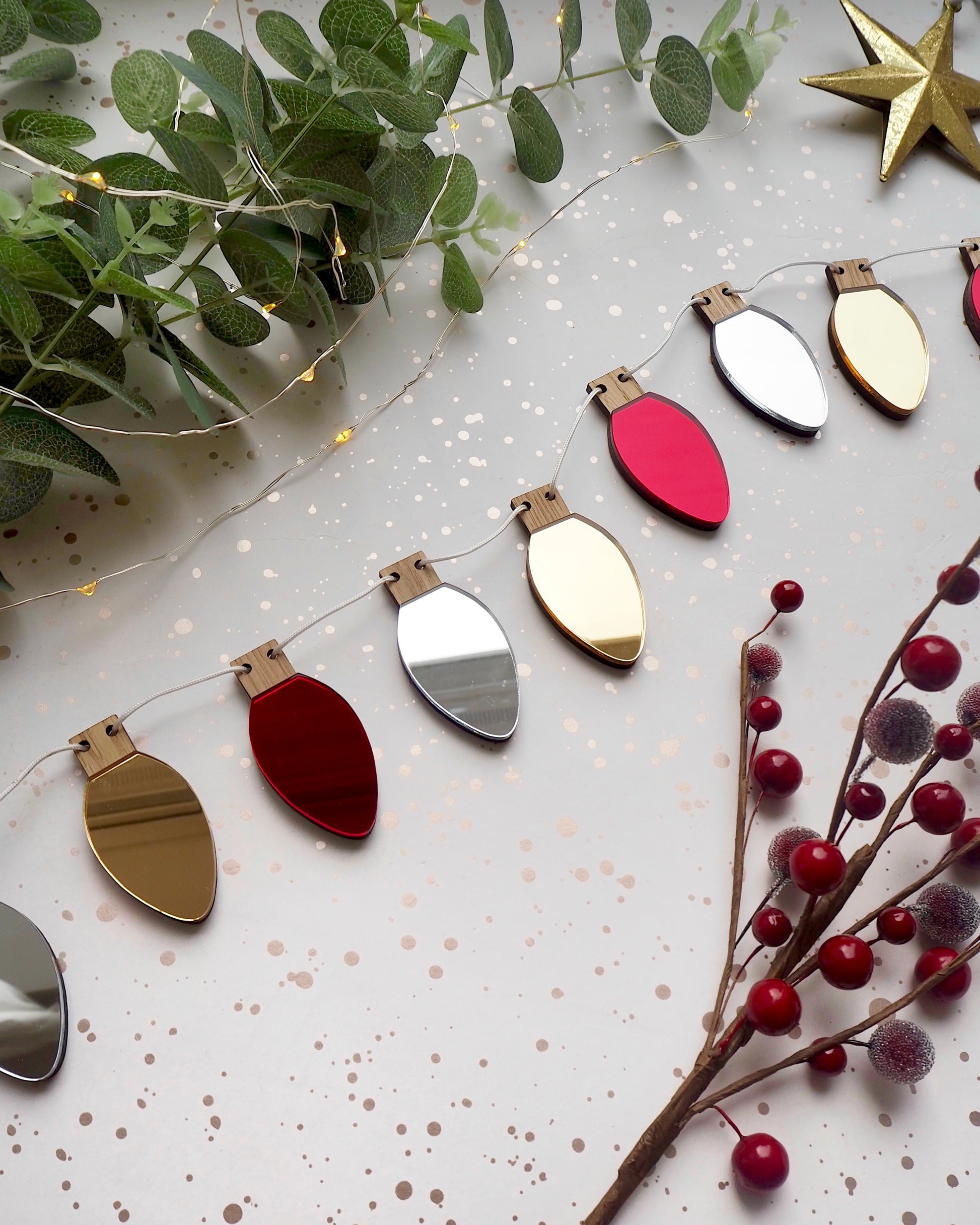 Metallic red silver and gold Christmas garland in the shape of fairy lights