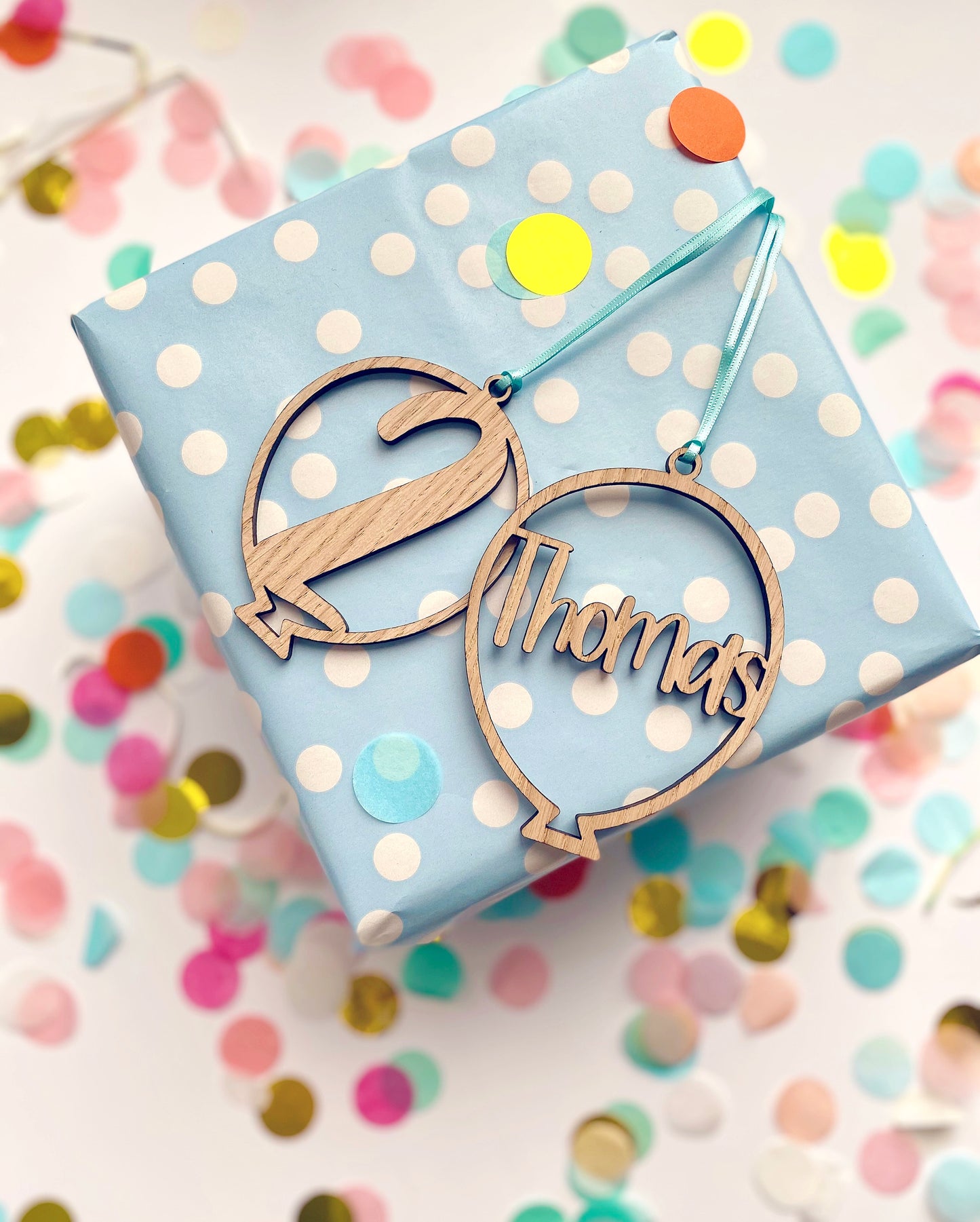 Wooden birthday gift tags in a balloon shape with a name and an age laser cut out