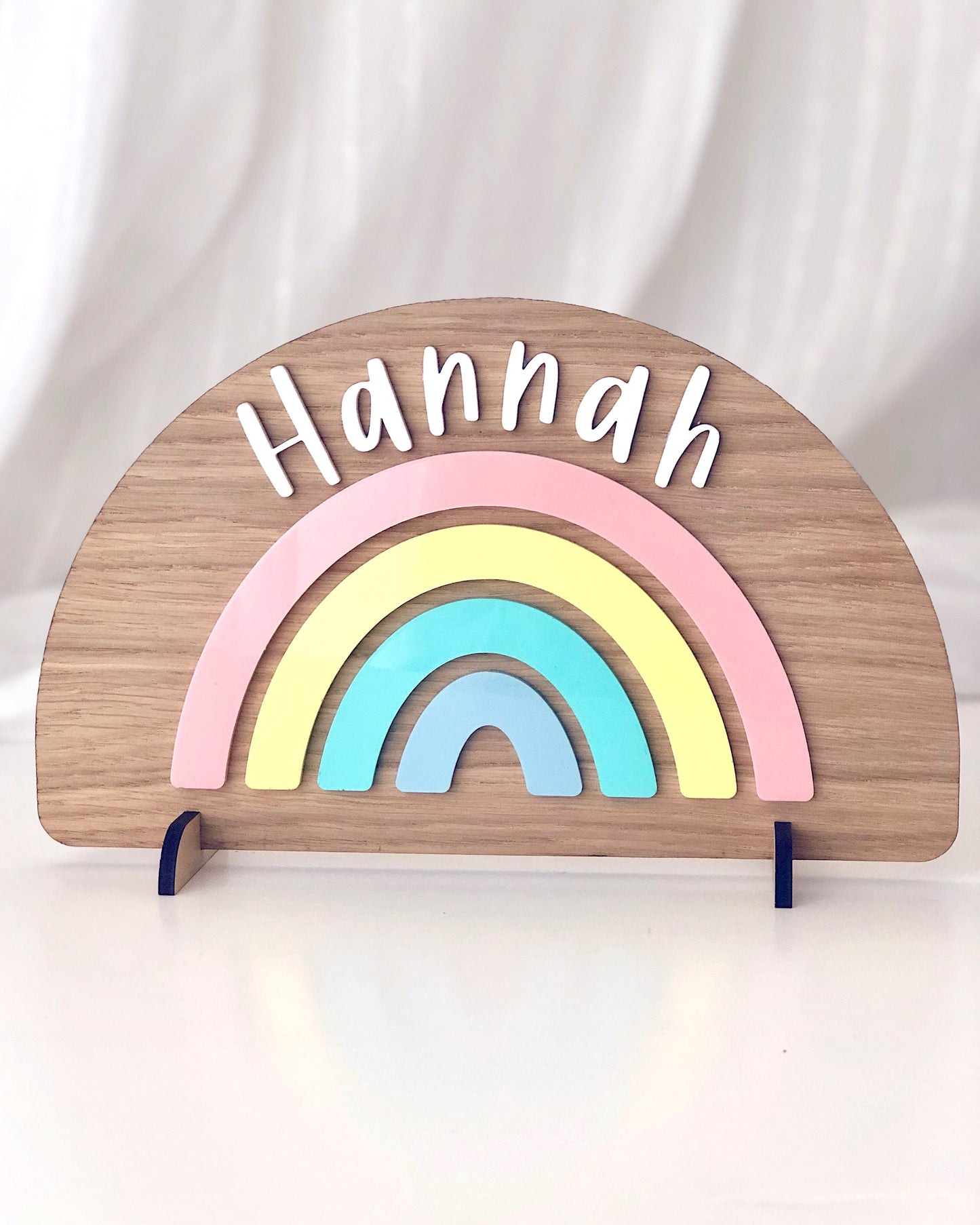 Freestanding wooden rainbow with colourful pastel acrylic details