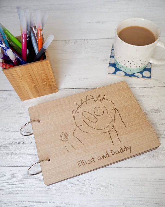 Wooden scrapbook with child's drawing engraved  on the front