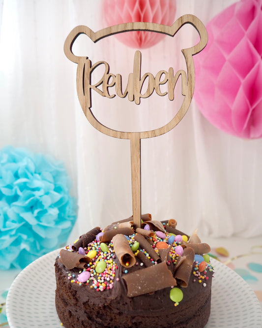 wooden bear shaped birthday cake topper with name laser cut from the middle 