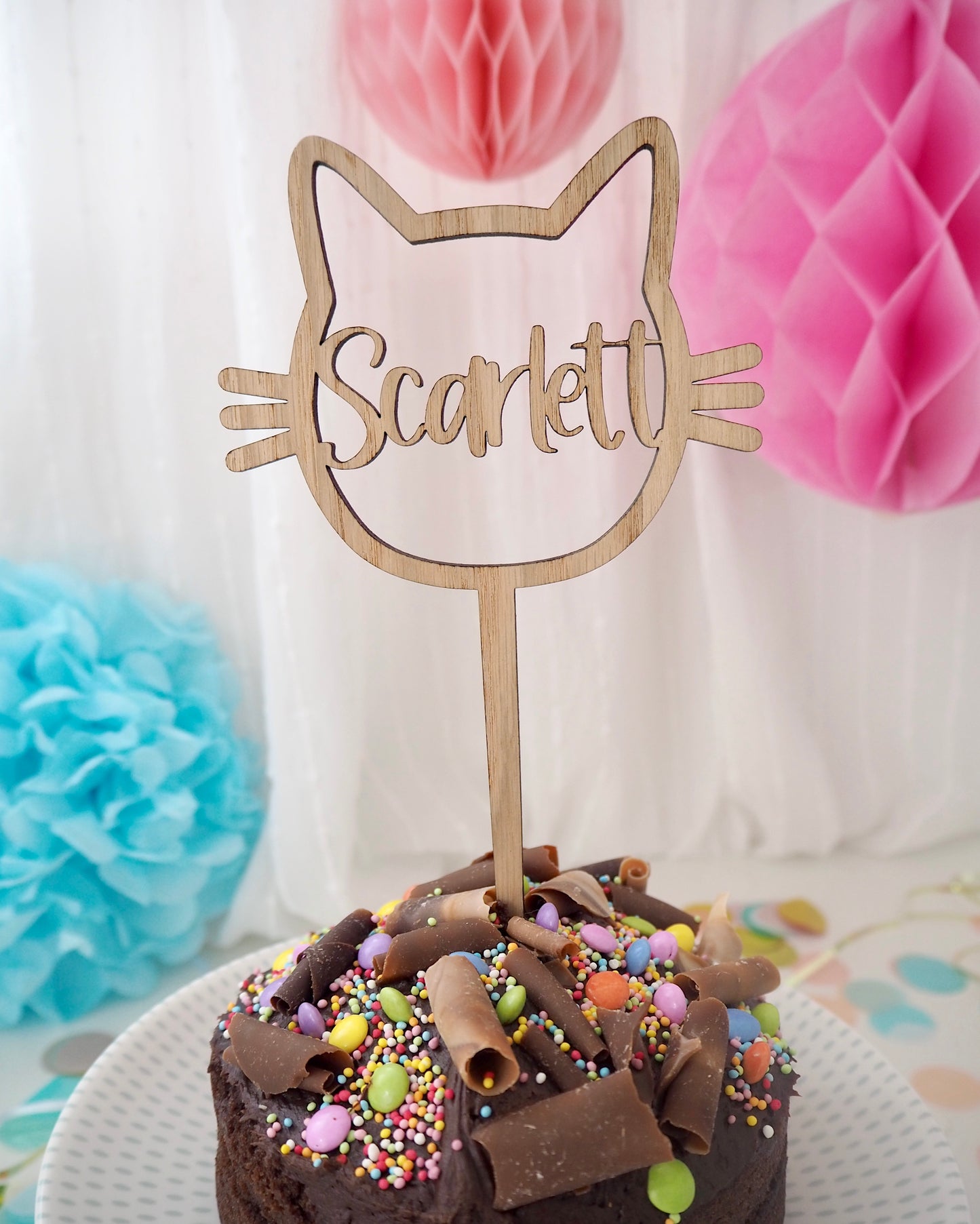 wooden cake topper in the shape of a cat personalised with a name cut out