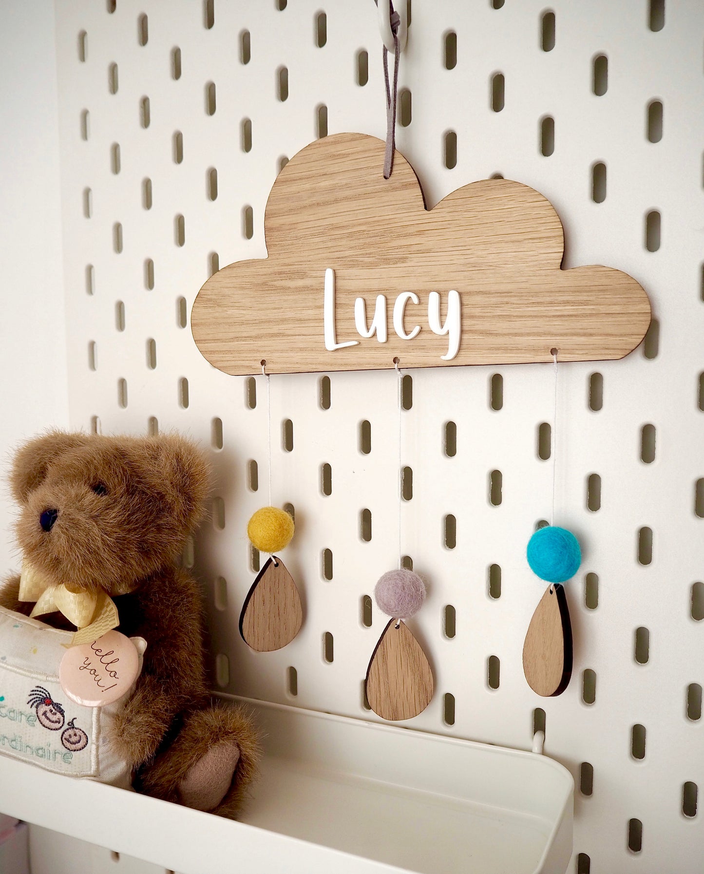 Wooden cloud with wooden raindrops and felt pom poms. Personalised name on cloud in acrylic letters