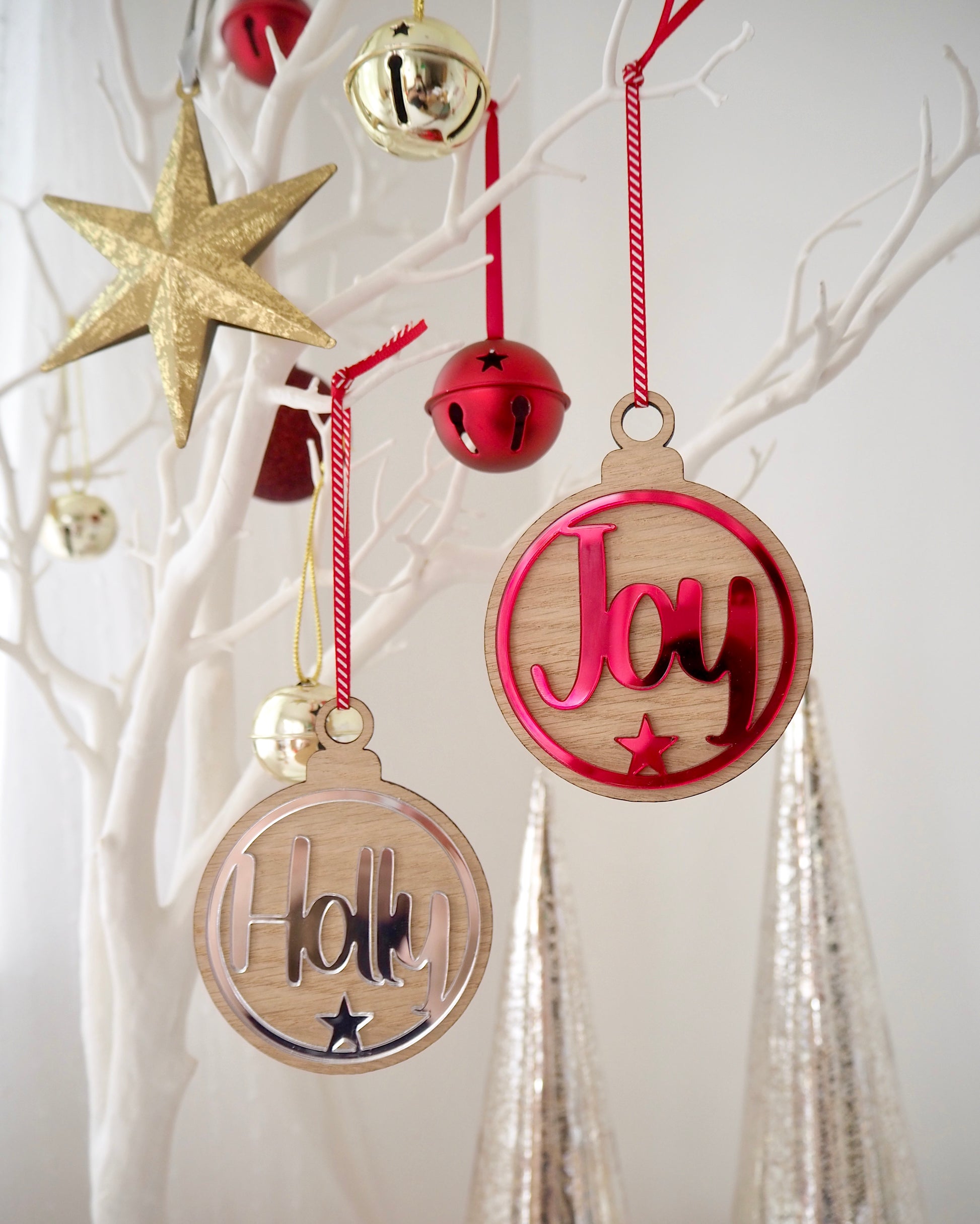 Wooden Christmas baubles with metallic acrylic in red or silver. Personalised with a name