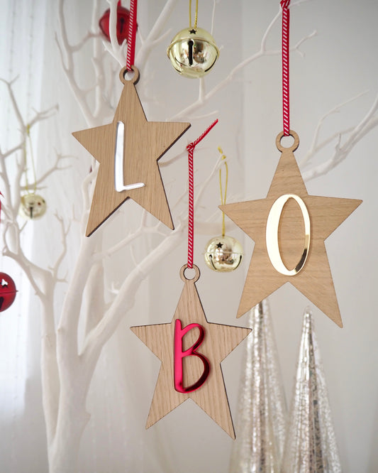 Wooden star decorations with red, gold and silver letters on