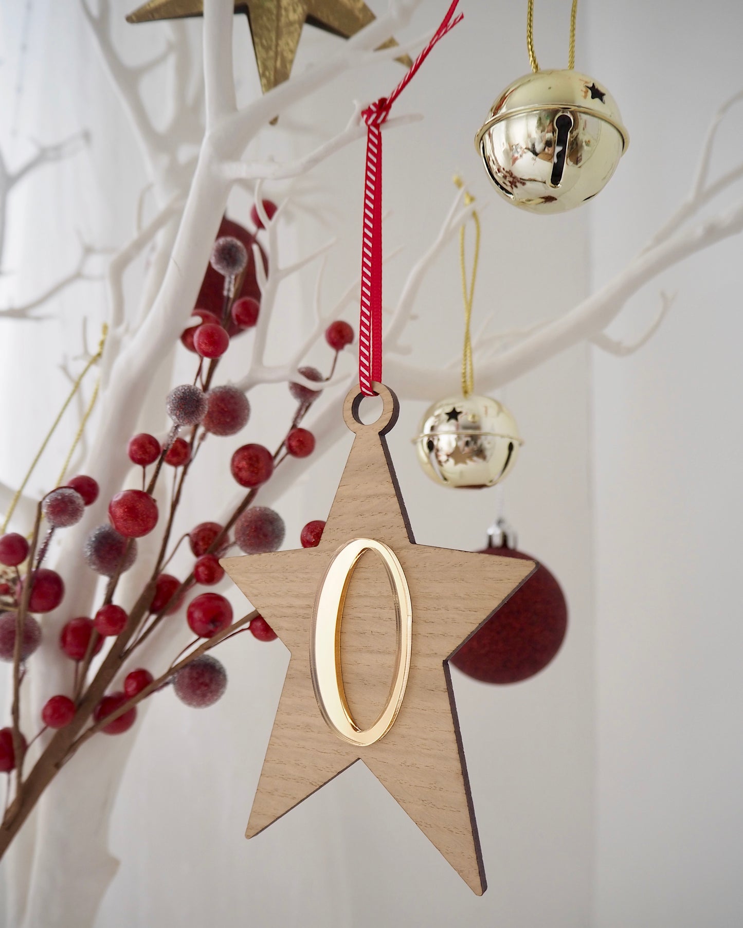 Wooden star Christmas decoration with metallic gold letter on the front