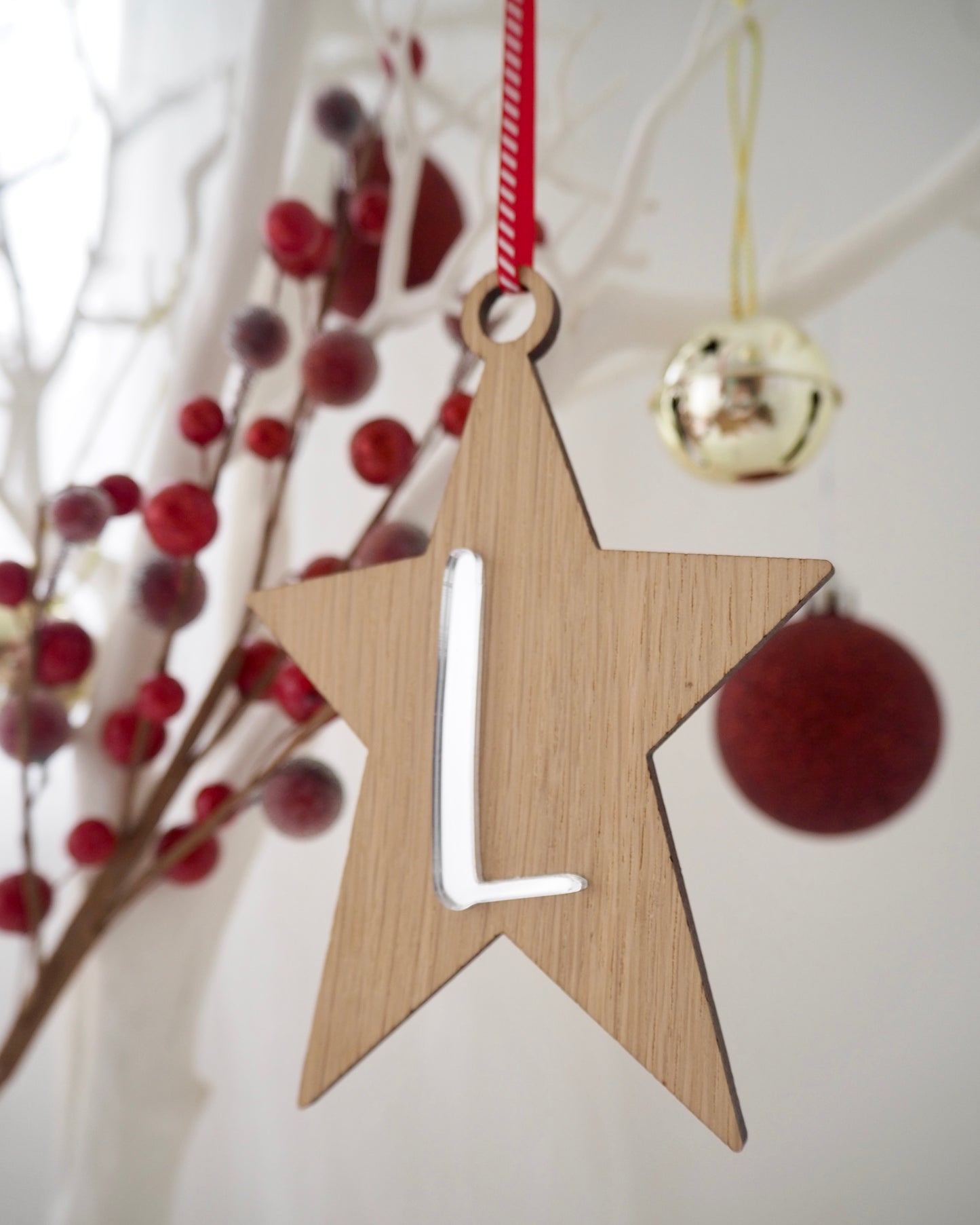 Wooden star Christmas decoration with metallic silver letter on the front